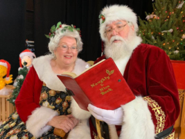 Mrs. Claus and the Big Red Santa check the Naughty & Nice Book