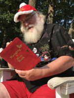 Big Red Santa on vacation - checking the Naughty & Nice List